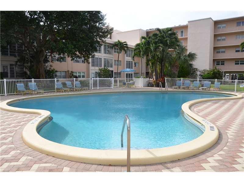 1481 South Ocean Boulevard, Unit 332C Pompano Beach, FL 33062 - Photo 11 of 24 a view of a swimming pool with a lounge chairs