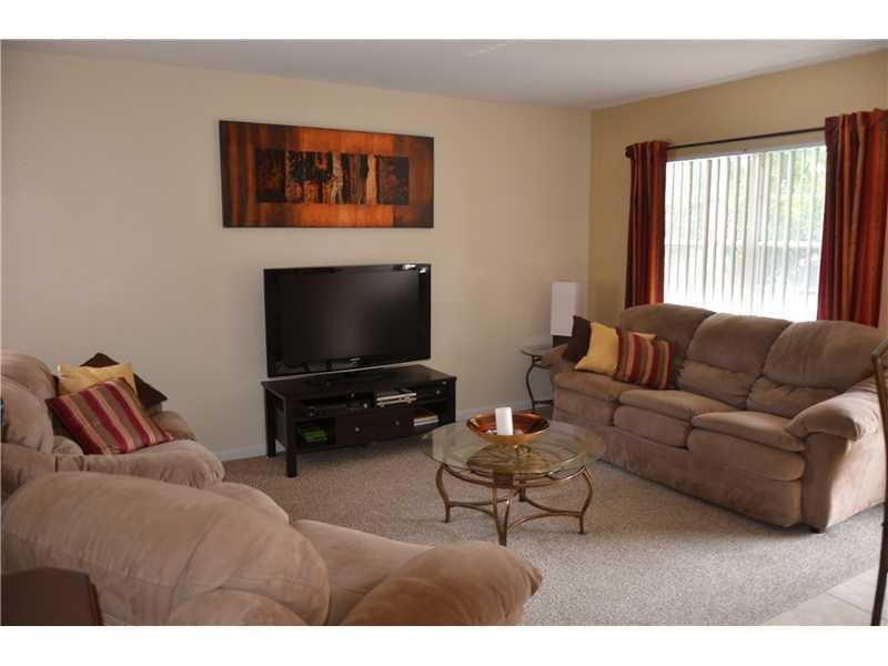 1481 South Ocean Boulevard, Unit 332C Pompano Beach, FL 33062 - Photo 8 of 24 a living room with furniture and a flat screen tv
