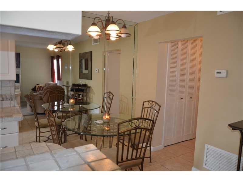 1481 South Ocean Boulevard, Unit 332C Pompano Beach, FL 33062 - Photo 9 of 24 a view of a dining room with furniture and chandelier