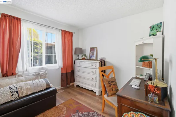 a bedroom with furniture and a window