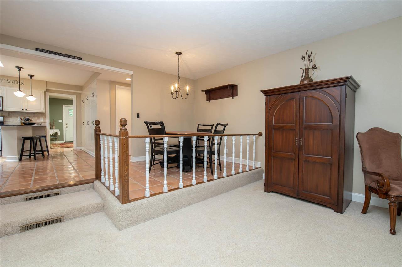 4716 Spring Creek Road Rockford, IL 61114 - Photo 13 of 50 a view of a livingroom with furniture wooden floor and chandelier