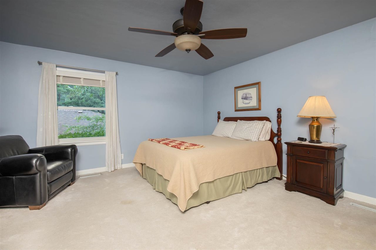 4716 Spring Creek Road Rockford, IL 61114 - Photo 17 of 50 a bedroom with a bed couches and window