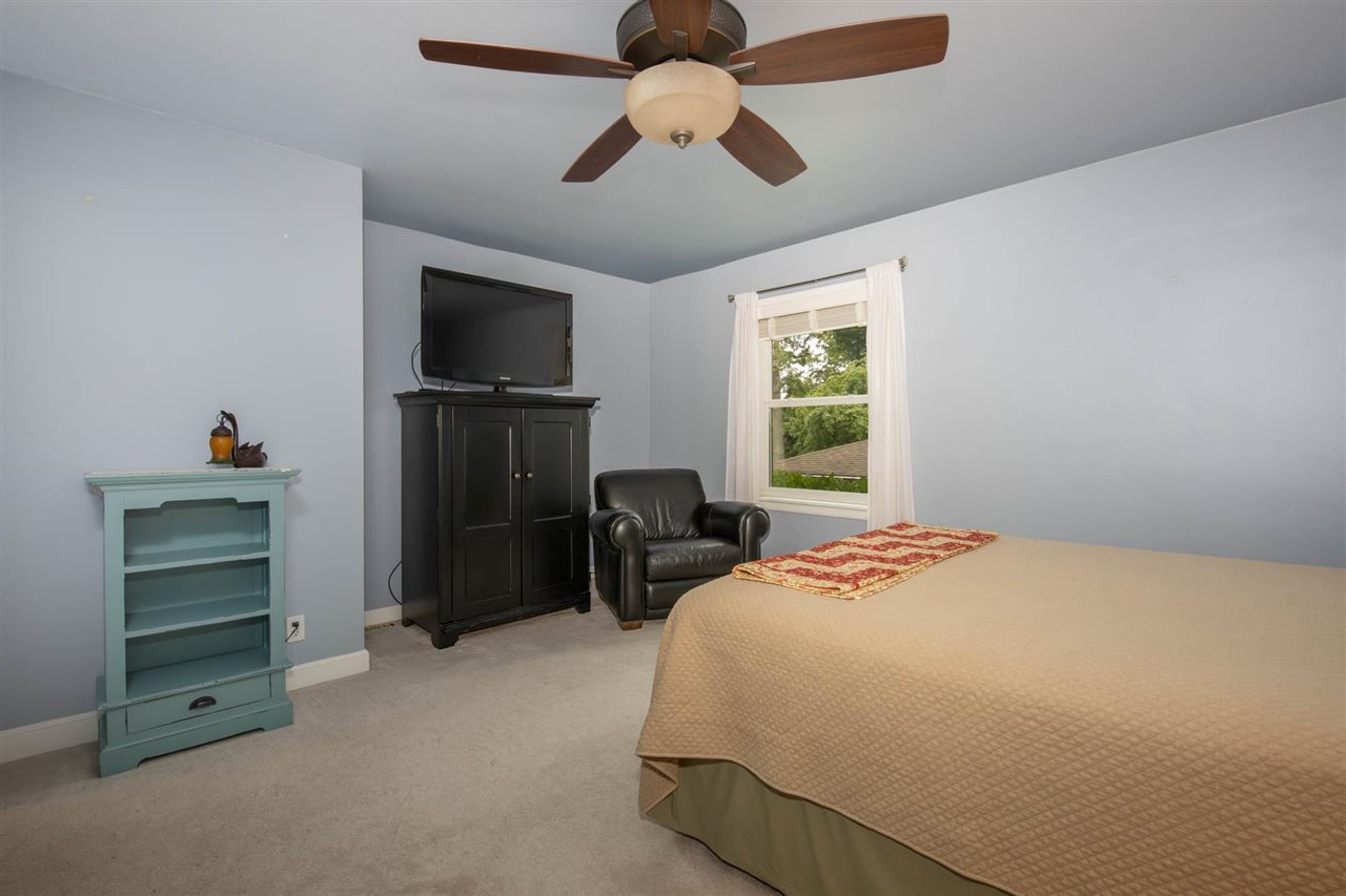 4716 Spring Creek Road Rockford, IL 61114 - Photo 18 of 50 a bedroom with a bed and a television