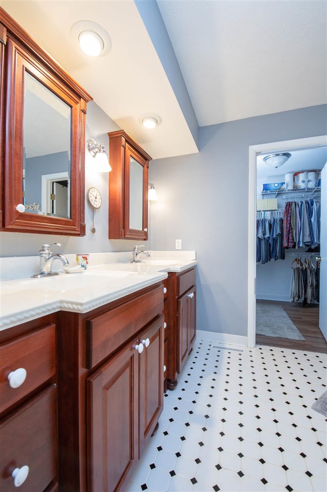 4716 Spring Creek Road Rockford, IL 61114 - Photo 19 of 50 a bathroom with a sink a mirror and a shower