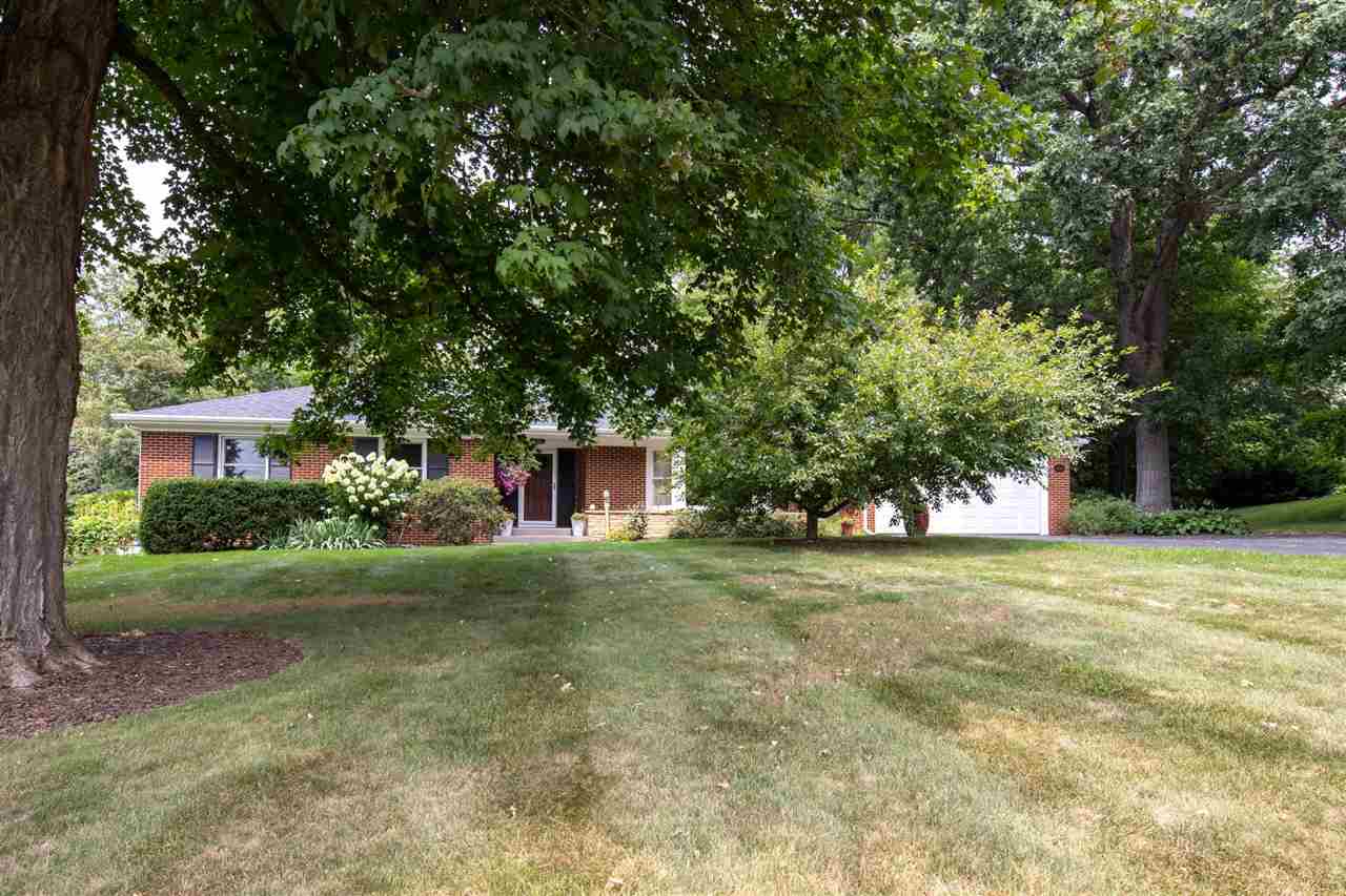 4716 Spring Creek Road Rockford, IL 61114 - Photo 2 of 50 a front view of a house with a yard and trees