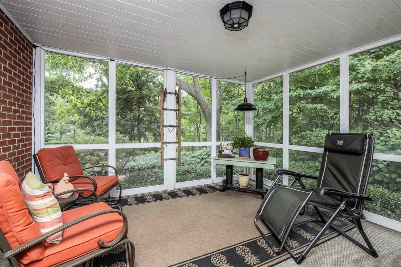 4716 Spring Creek Road Rockford, IL 61114 - Photo 35 of 50 a living room with furniture and a floor to ceiling window