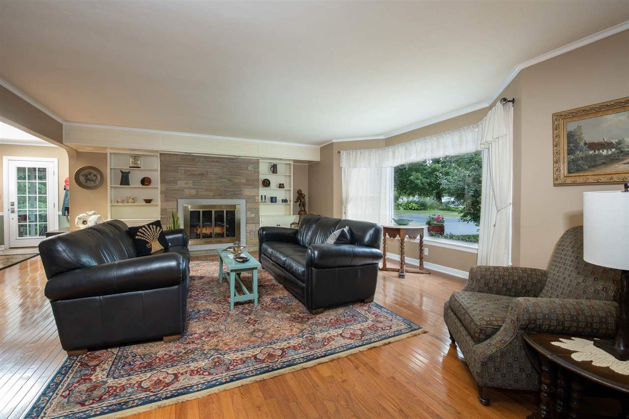 4716 Spring Creek Road Rockford, IL 61114 - Photo 4 of 50 a living room with furniture and a fireplace
