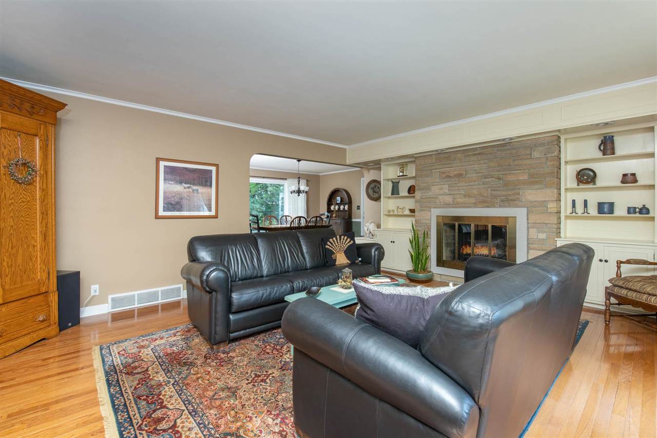 4716 Spring Creek Road Rockford, IL 61114 - Photo 5 of 50 a living room with furniture and a fireplace