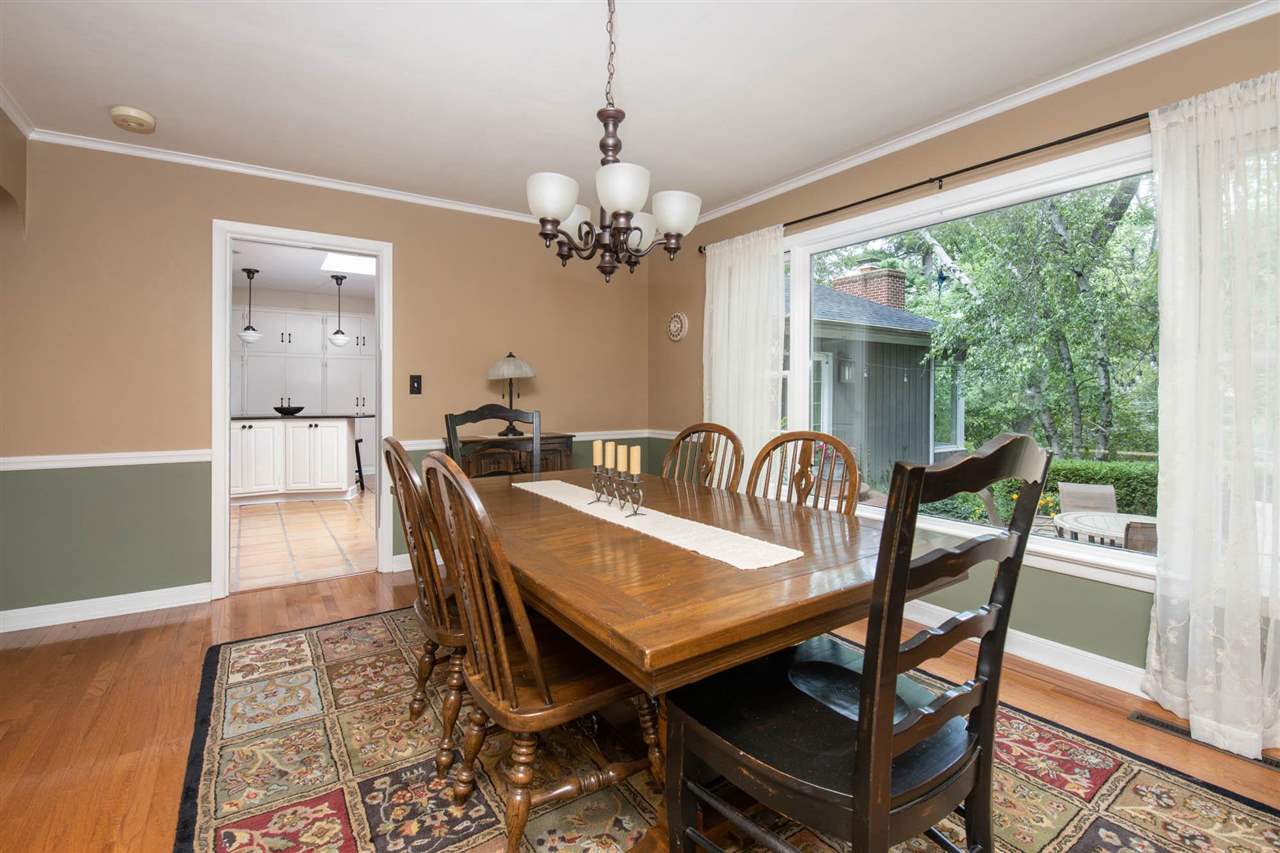 4716 Spring Creek Road Rockford, IL 61114 - Photo 6 of 50 a dining room with furniture a rug a potted plant and a chandelier