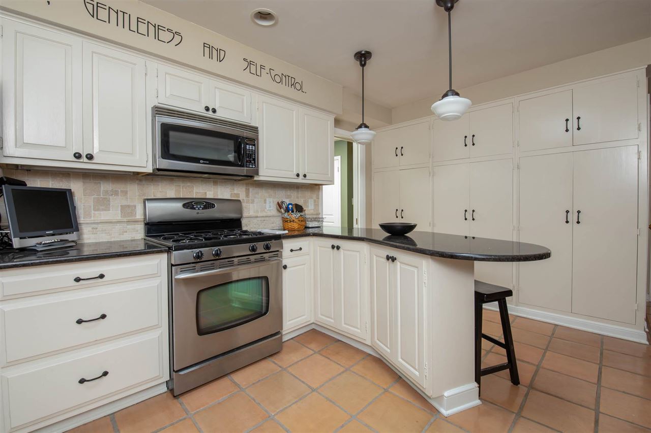 4716 Spring Creek Road Rockford, IL 61114 - Photo 8 of 50 a kitchen with stainless steel appliances granite countertop a sink a stove a microwave and wooden cabinets