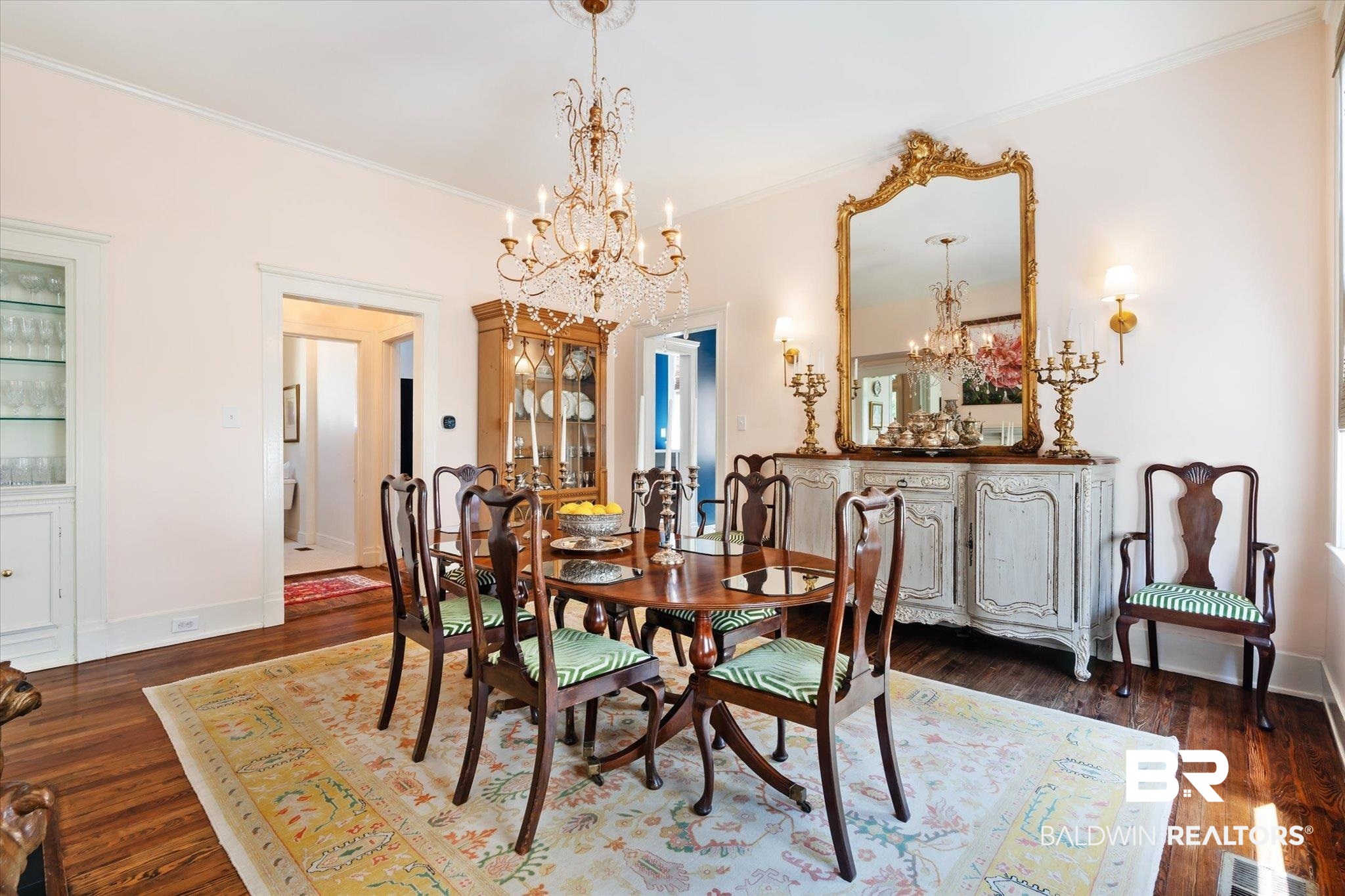 68 North Monterey Street Mobile, AL 36604 - Photo 9 of 30 Dining room featuring dark wood-type flooring, ornamental molding, and an inviting chandelier