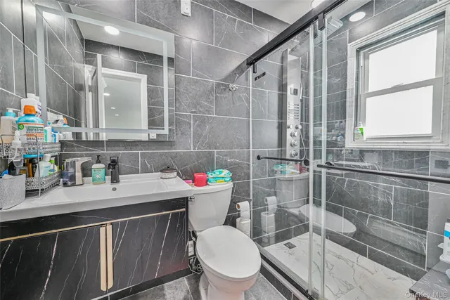 a bathroom with a sink a toilet and a shower