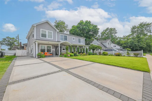 a front view of house with yard and green space