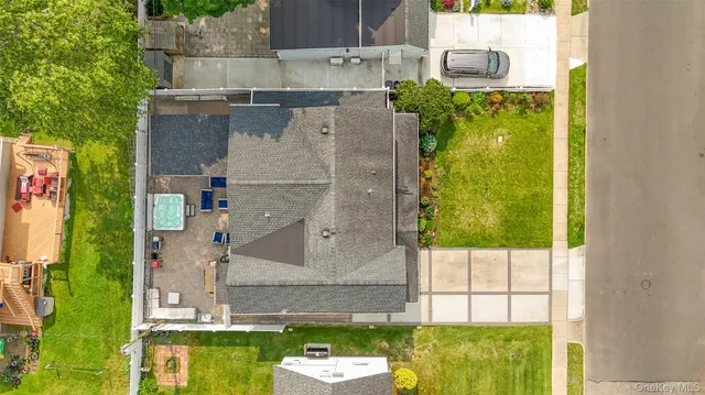 a aerial view of a house with a yard and large tree