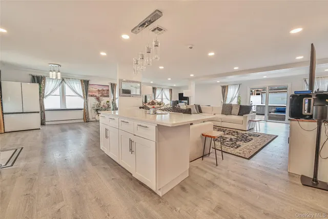 a kitchen with stainless steel appliances kitchen island granite countertop a stove and a sink