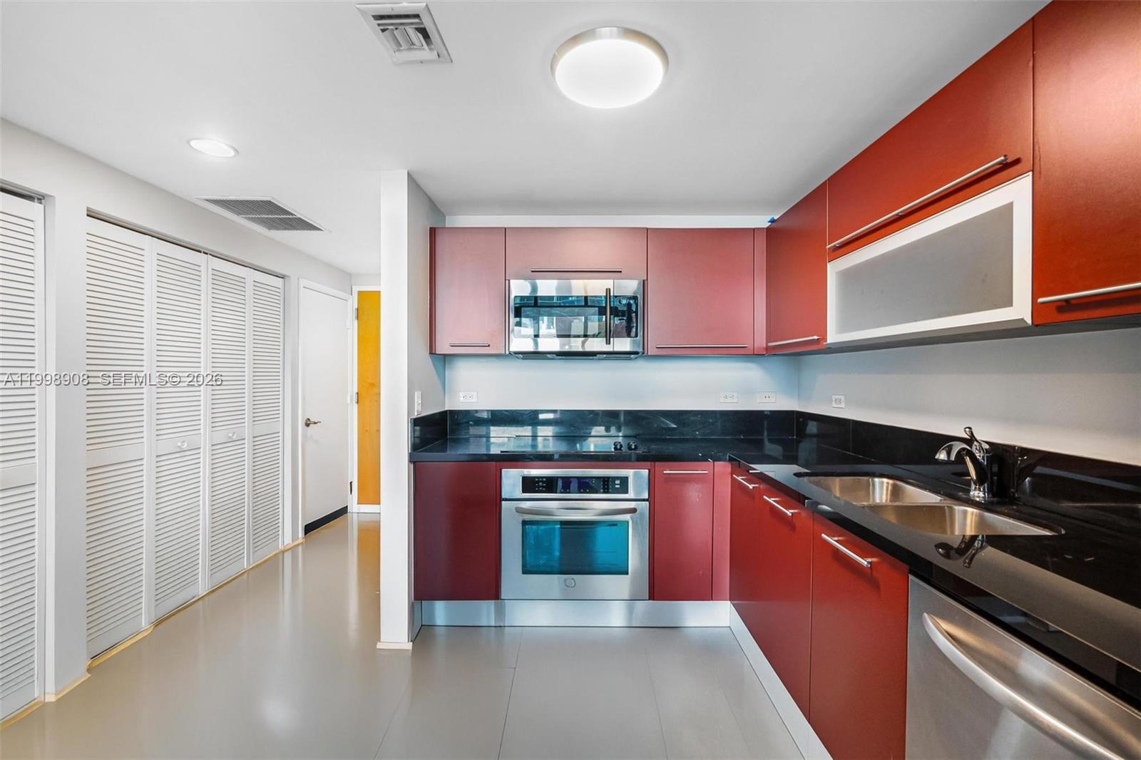 244 Biscayne Boulevard, Unit 445 Miami, FL 33132 - Photo 12 of 35 a kitchen with stainless steel appliances granite countertop a stove and a sink