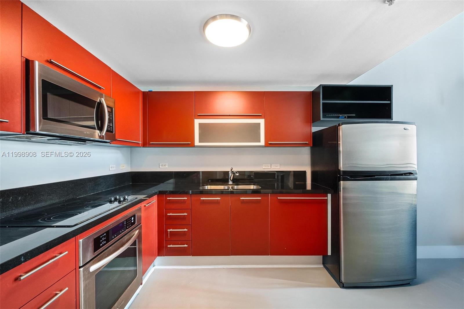 244 Biscayne Boulevard, Unit 445 Miami, FL 33132 - Photo 13 of 35 a kitchen with stainless steel appliances granite countertop a refrigerator and a microwave