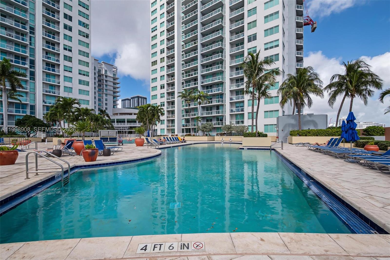 244 Biscayne Boulevard, Unit 445 Miami, FL 33132 - Photo 25 of 35 a swimming pool with outdoor seating and garden
