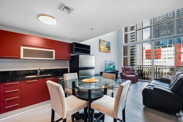a dining room with furniture and window