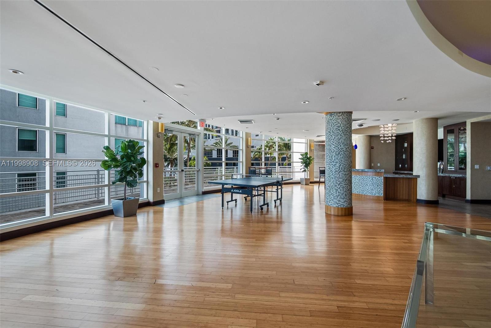 244 Biscayne Boulevard, Unit 445 Miami, FL 33132 - Photo 31 of 35 an empty room with wooden floor and outdoor view