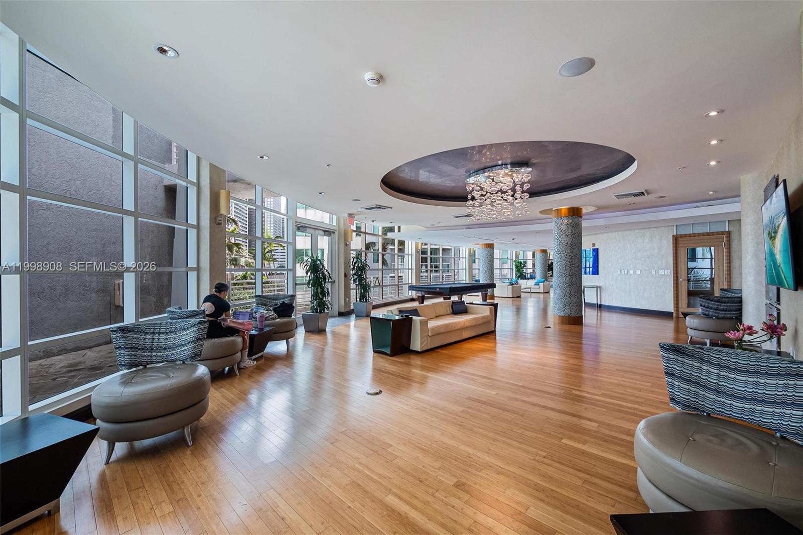 244 Biscayne Boulevard, Unit 445 Miami, FL 33132 - Photo 32 of 35 a living room with furniture and a wooden floor