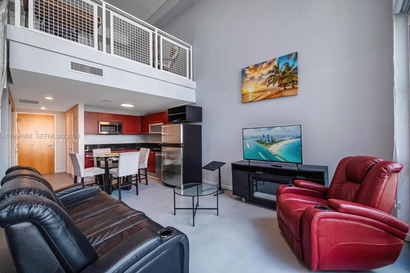 244 Biscayne Boulevard, Unit 445 Miami, FL 33132 - Photo 4 of 35 a living room with furniture ceiling fan and a rug