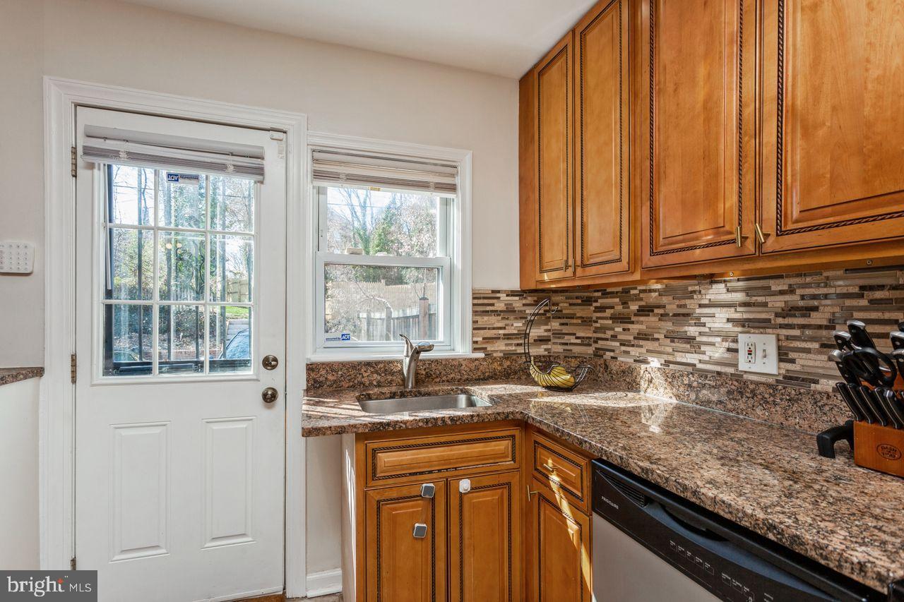 3920 Rexmere Road Baltimore, MD 21218 - Photo 11 of 35 a kitchen with granite countertop stainless steel appliances a sink window and cabinets