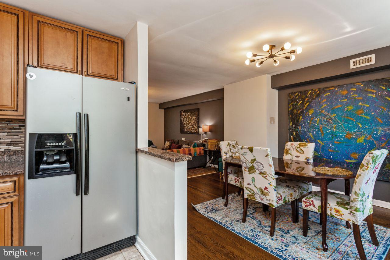 3920 Rexmere Road Baltimore, MD 21218 - Photo 12 of 35 a view of a dining room with furniture a chandelier and wooden floor