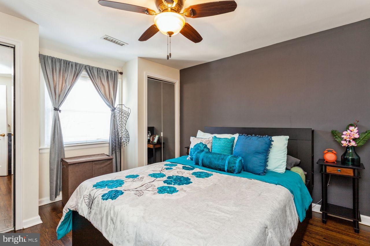 3920 Rexmere Road Baltimore, MD 21218 - Photo 15 of 35 a bedroom with a bed and a chandelier