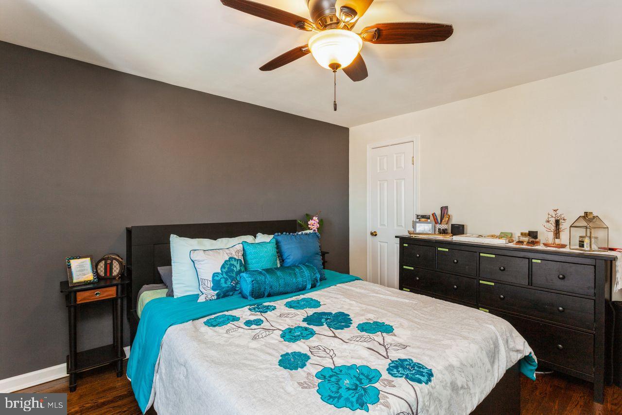 3920 Rexmere Road Baltimore, MD 21218 - Photo 17 of 35 a bedroom with a bed and a chandelier