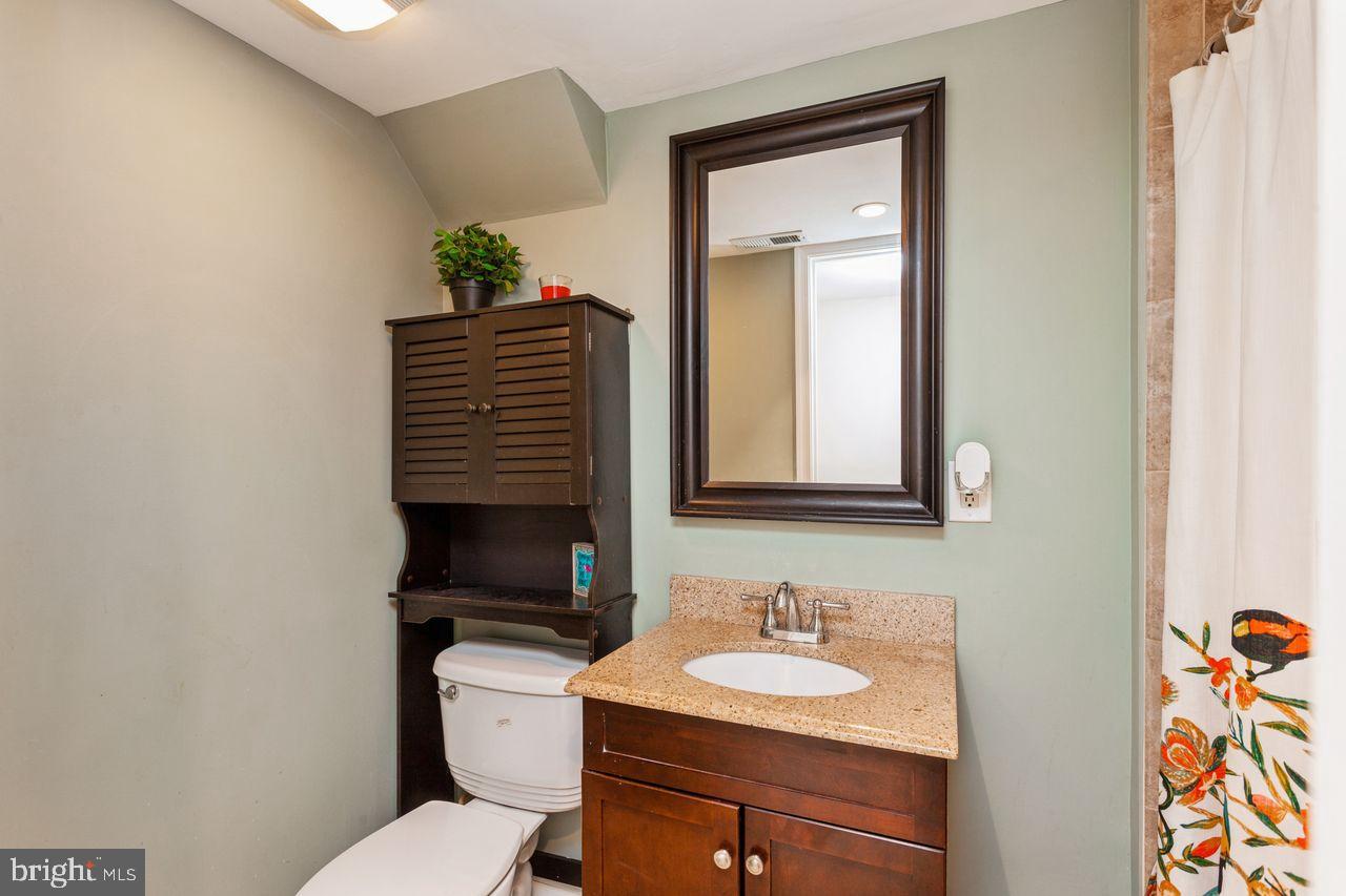 3920 Rexmere Road Baltimore, MD 21218 - Photo 27 of 35 a bathroom with a toilet sink and mirror