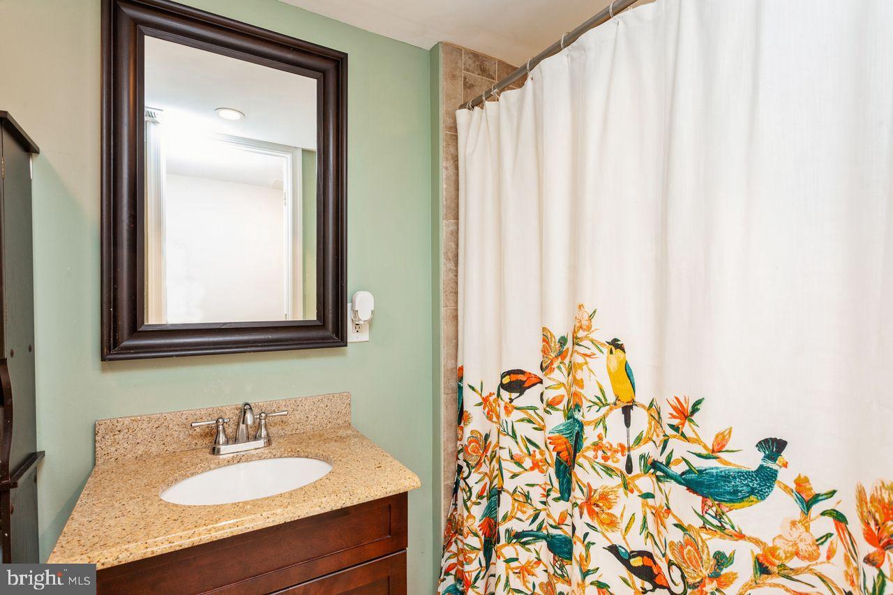 3920 Rexmere Road Baltimore, MD 21218 - Photo 28 of 35 a bathroom with a sink and a mirror