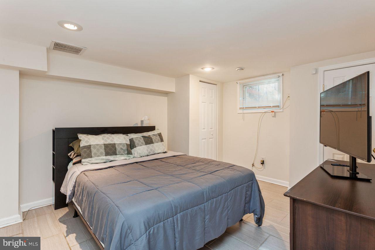 3920 Rexmere Road Baltimore, MD 21218 - Photo 30 of 35 a bedroom with a bed and a flat screen tv