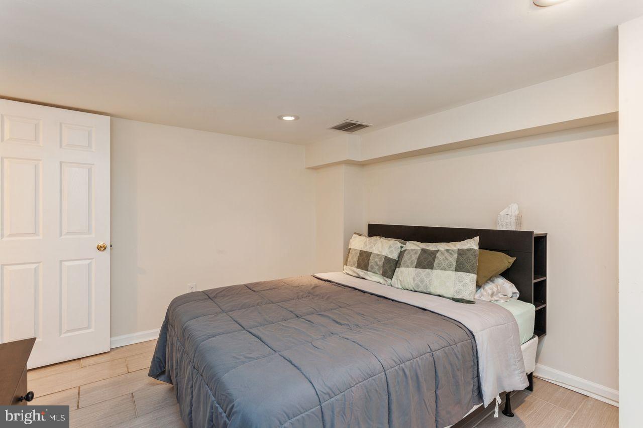 3920 Rexmere Road Baltimore, MD 21218 - Photo 31 of 35 a bedroom with a bed and a painting on the wall