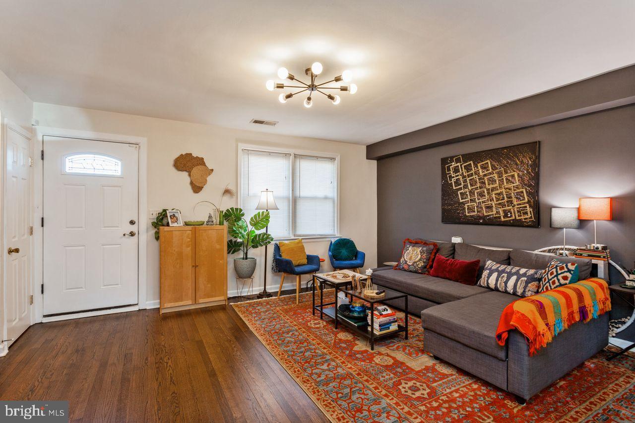 3920 Rexmere Road Baltimore, MD 21218 - Photo 5 of 35 a living room with furniture a chandelier and a rug