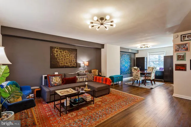 a living room with furniture and wooden floor