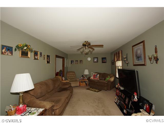 12112 Quito Road Midlothian, VA 23112 - Photo 4 of 7 a living room with furniture and a flat screen tv