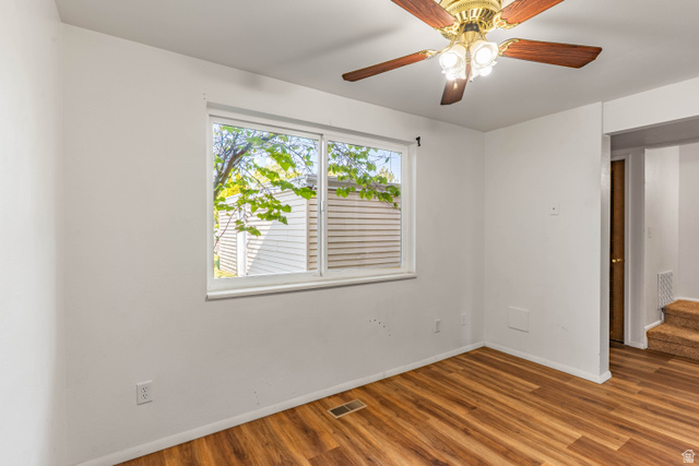 728 400 East Orem, UT 84097 - Photo 11 of 30 Room featuring wood-finish flooring, a double-pane window, and a ceiling fan with integrated lighting