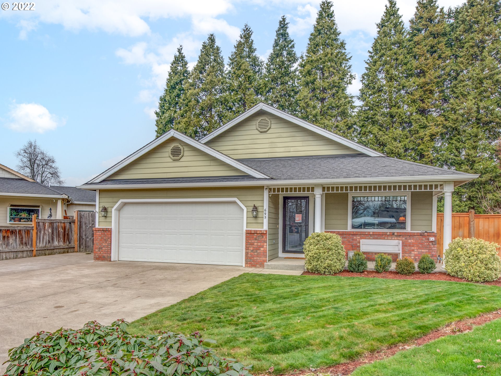 695 62nd Street Springfield, OR 97478 - Photo 1 of 30 a front view of a house with a yard and garage