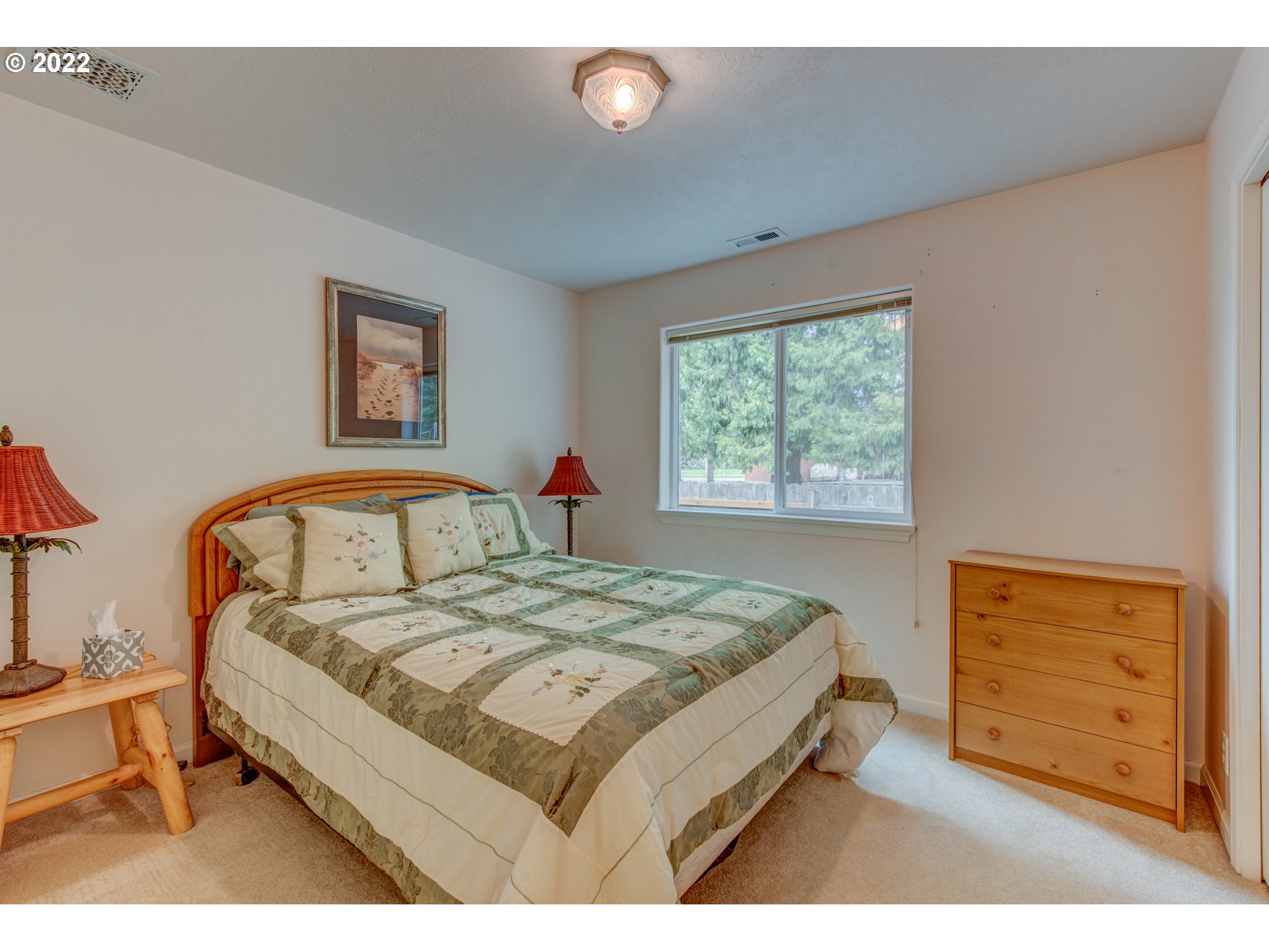 695 62nd Street Springfield, OR 97478 - Photo 20 of 30 a bed sitting in a bedroom next to a window