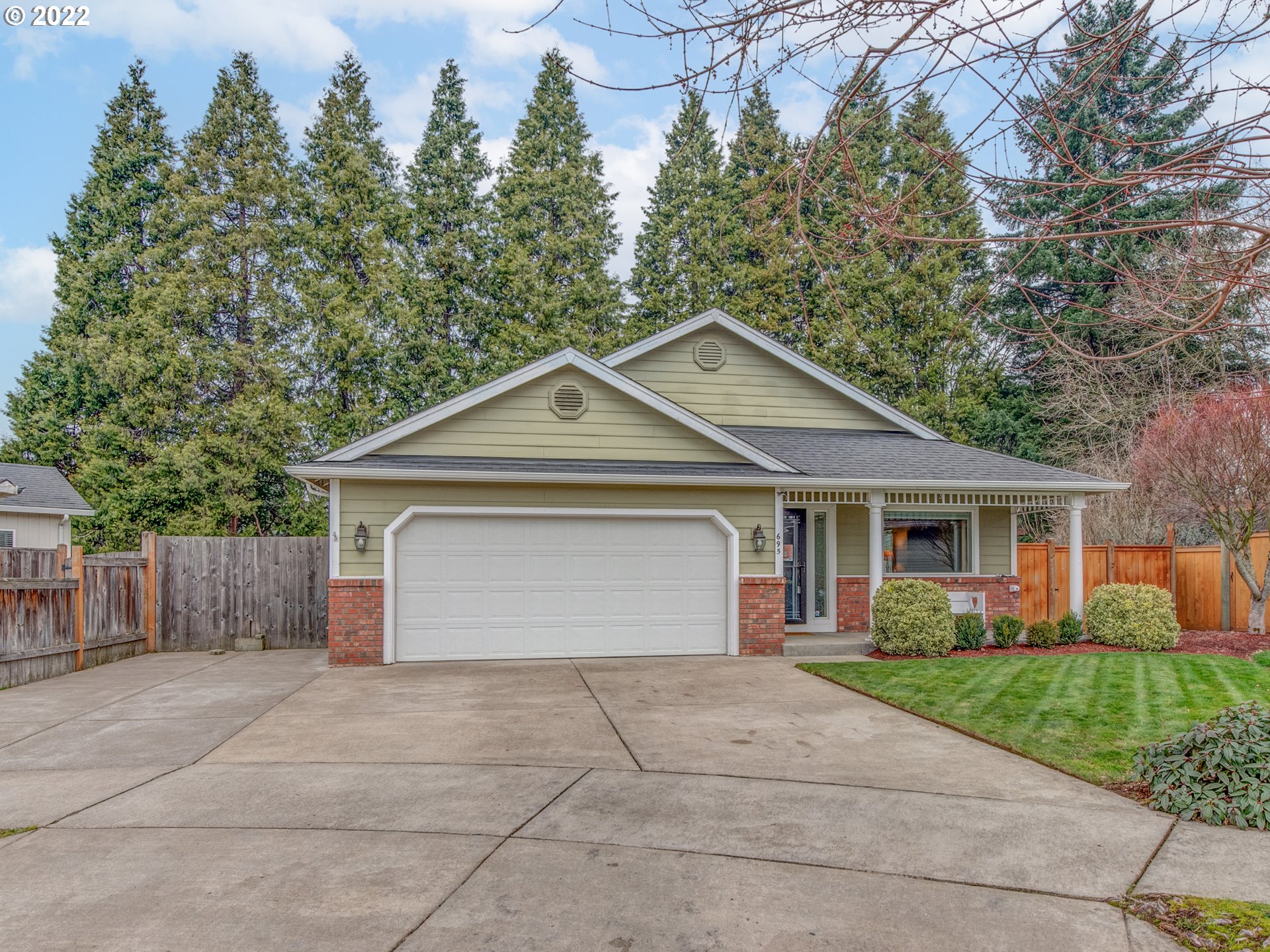 695 62nd Street Springfield, OR 97478 - Photo 2 of 30 a front view of a house with a yard and trees