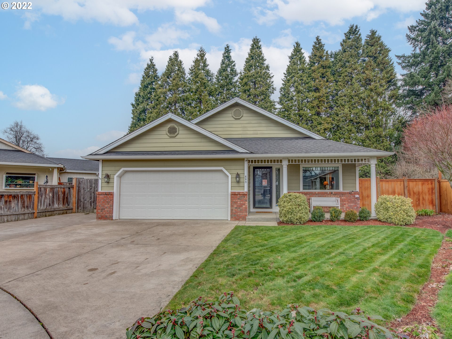 695 62nd Street Springfield, OR 97478 - Photo 3 of 30 a front view of a house with a yard and trees