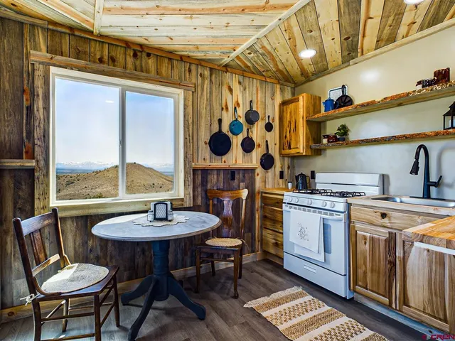 a living room with furniture and wooden floors