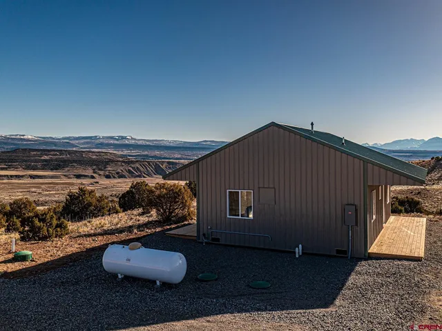 a house with green field in front of it