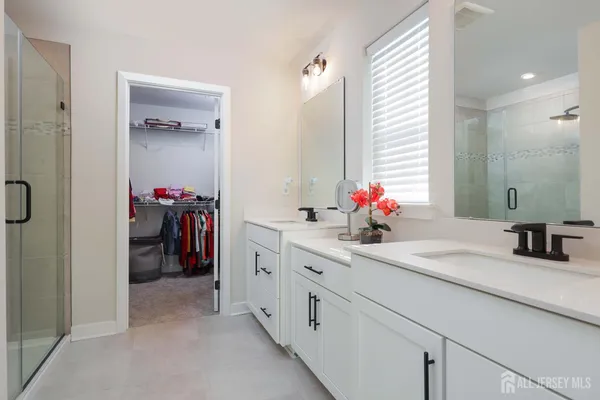 a bathroom with a sink double vanity and a mirror