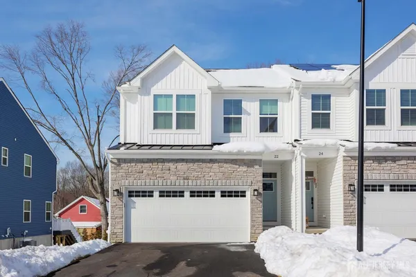 a front view of a house with large windows
