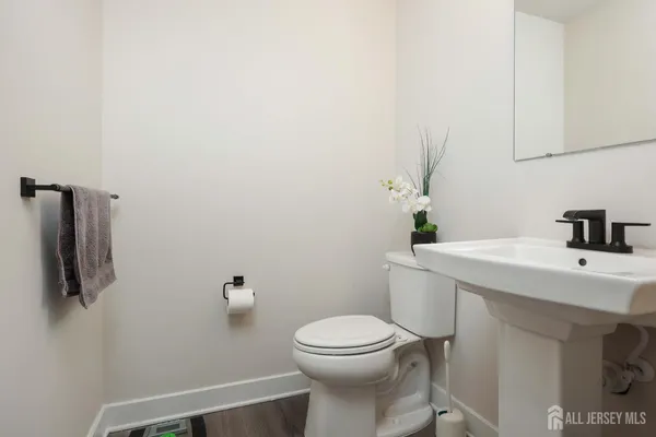 a bathroom with a sink a toilet and mirror