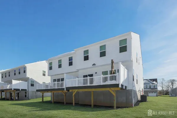 a large building with a big yard and more windows