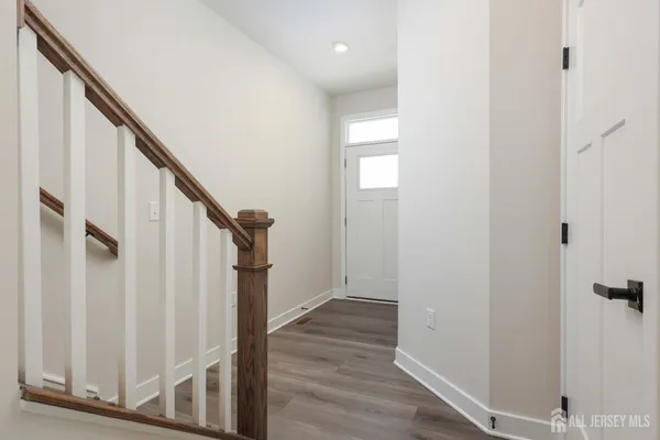 a view of entryway with wooden floor and stairs