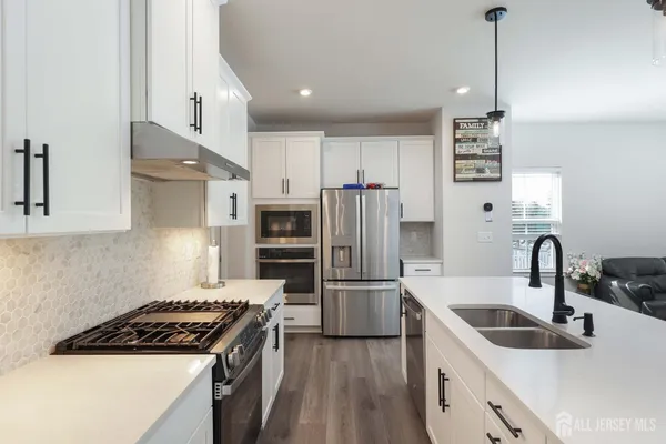 a kitchen with refrigerator a sink and kitchen island